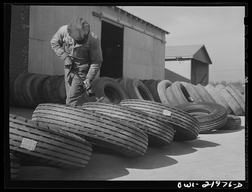 Untitled photo, possibly related to: Charlotte, North Carolina. Branding tires with serial numbers at the Associated Transport Company terminal
