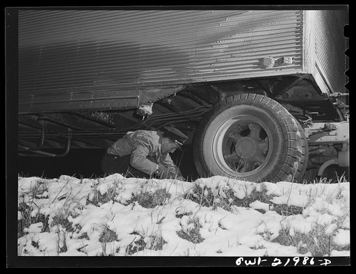 Untitled photo, possibly related to: Jim Fletcher putting on chains while crossing mountains in eastern Tennessee