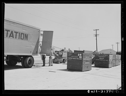 Untitled photo, possibly related to: Gunter Field, Alabama. Loading airplane motors onto trucks. They are being shipped to Macon, Georgia for repairs