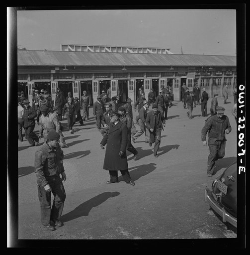 Untitled photo, possibly related to: Baltimore, Maryland. Workers hurrying to catch a trolley and a trackless trolley at seven a.m.