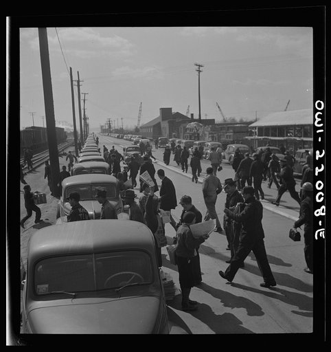 Baltimore, Maryland. Second shift workers leaving the Bethlehem Fairfield shipyard at three p.m. making a dash for cars parked along the road