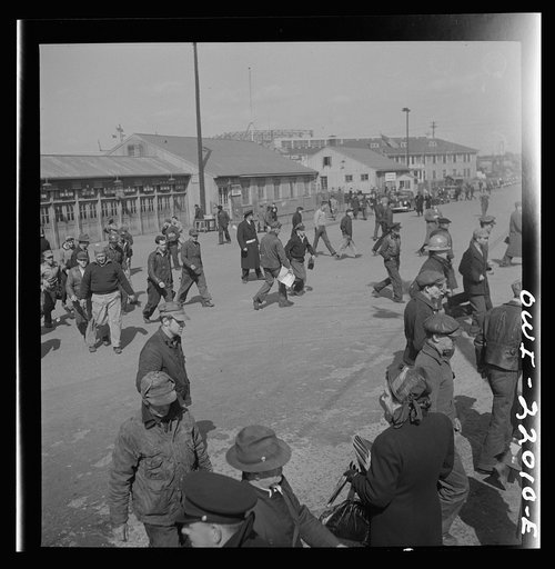 Untitled photo, possibly related to: Baltimore, Maryland. Workers hurrying to catch a trolley and a trackless trolley at seven a.m.