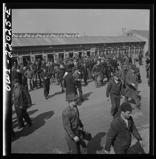 Untitled photo, possibly related to: Baltimore, Maryland. Workmen of the second shift of the Bethlehem Fairfield shipyard lining up at the gate waiting to get on trolleys at three p.m.