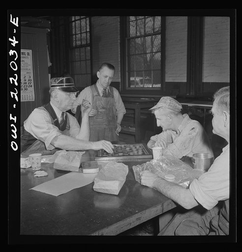 Baltimore, Maryland. Employees of the paint shop playing checkers during lunch at the Washington terminal of the Baltimore Transit Company where trolleys and buses are maintained and repaired. Employees who work on trolleys are noticeably older than those on buses because trolleys have been in exist