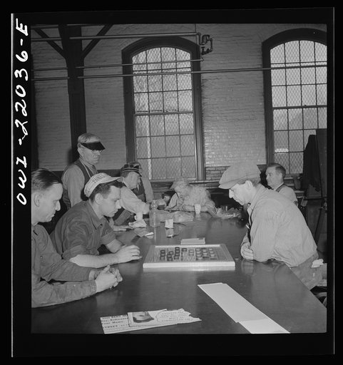 Baltimore, Maryland. Employees of the paint shop playing checkers during lunch hour at the Washington terminal of the Baltimore Transit Company where trolleys and buses are maintained and repaired. Employees who work on trolleys are noticeably older than those on buses because trolleys have been in 