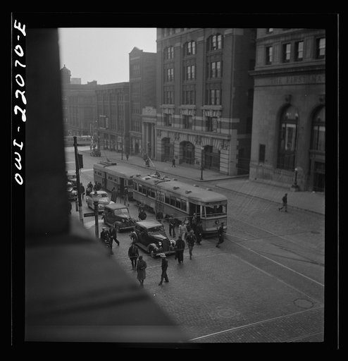 Untitled photo, possibly related to: Baltimore, Maryland. Continuous stream of trolleys carrying workers from the Bethlehem Fairfield shipyard to downtown Baltimore disgorges passengers who rush for other trolleys and buses. Trolleys from other parts of the city are sent to this route at hours of th