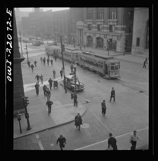 Untitled photo, possibly related to: Baltimore, Maryland. Continuous stream of trolleys carrying workers from the Bethlehem Fairfield shipyard to downtown Baltimore disgorges passengers who rush for other trolleys and buses. Trolleys from other parts of the city are sent to this route at hours of th