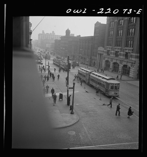 Untitled photo, possibly related to: Baltimore, Maryland. Continuous stream of trolleys carrying workers from the Bethlehem Fairfield shipyard to downtown Baltimore disgorges passengers who rush for other trolleys and buses. Trolleys from other parts of the city are sent to this route at hours of th