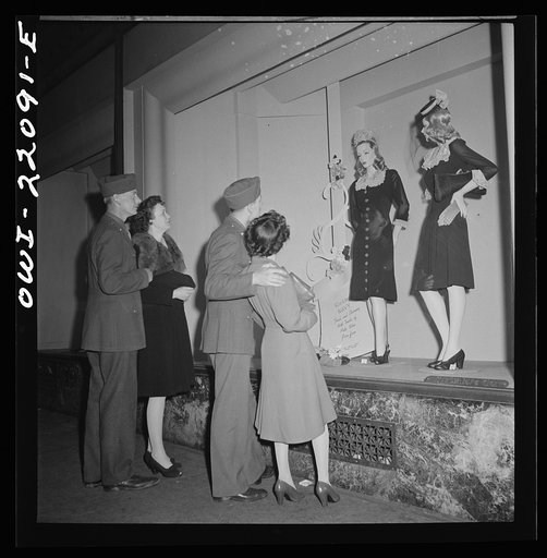 Baltimore, Maryland. Soldiers and their girls window shopping in the evening