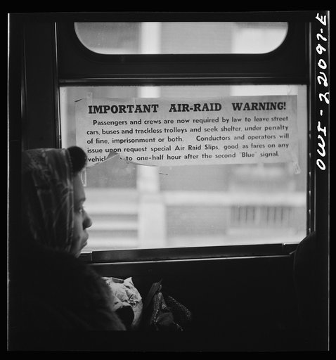 Baltimore, Maryland. Air raid notice on a bus window