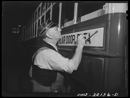 Baltimore, Maryland. Painting a sign on a trolley at the paint shop of the maintenance terminal of the Baltimore Transit Company