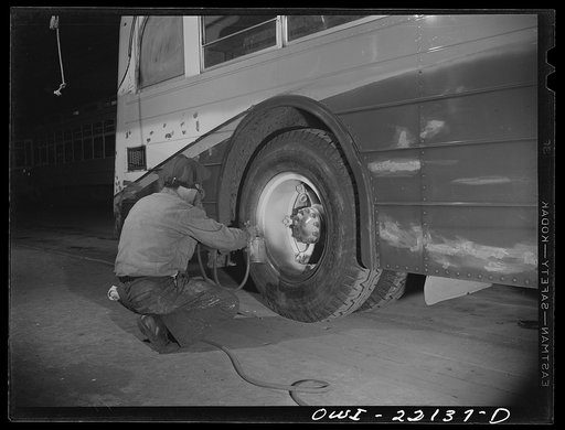 Baltimore, Maryland. Spraying paint on bus wheels at the maintenance terminal of the Baltimore Transit Company
