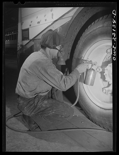 Baltimore, Maryland. Spraying paint on bus wheels at the maintenance terminal of the Baltimore Transit Company