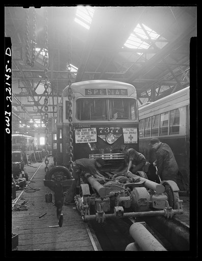 Untitled photo, possibly related to: Baltimore, Maryland. Repairing the motor of a PCC trolley. Most recent trolley model designed in 1936 by a group of manufacturers and transit companies in an effort to standardize, simplify, and bring down the price; at the damage shop, maintenance terminal of th