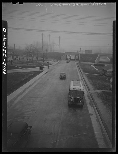 Baltimore, Maryland. Highway outside the Glenn L. Martin plant with cars arriving for the seven a.m. shift. Well-planned roads, and time staggering have eliminated heavy traffic
