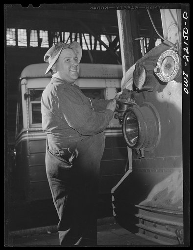 Baltimore, Maryland. Repairing electric connector at the end of a 1919 trolley, at the damage repair shop of the maintenance terminal of the Baltimore Transit Company