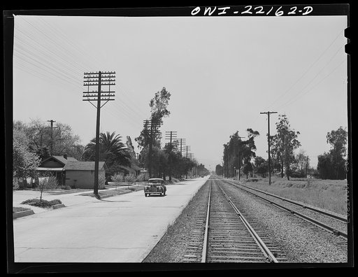 San Bernardino (vicinity), California. Atchison, Topeka, and Santa Fe Railroad tracks running along the highway