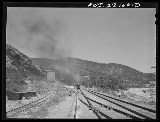 Atchison, Topeka, and Santa Fe Railroad helper engine stopping for water near Cajon, California during the climb from San Bernardino to Summit
