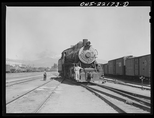 San Bernardino, California. Switch engine and switchman working in the yard used by the Atchison, Topeka, and Santa Fe Railroad
