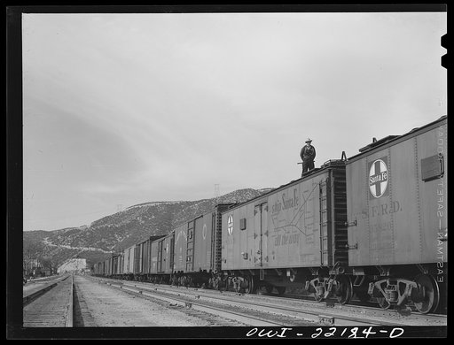 Cajon, California. Swing brakeman riding on top of the Atchison, Topeka and Santa Fe Railroad train. Brakeman ride the trains in this way during the entire descent from summit to San Bernardino