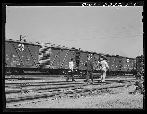 Untitled photo, possibly related to: San Bernardino, California. Yard crew working with a Atchison, Topeka, and Santa Fe Railroad diesel switch engine