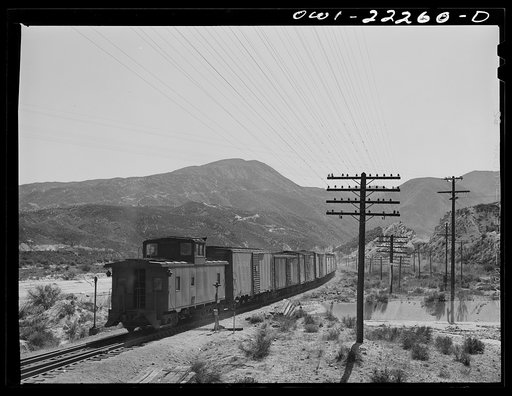 Eastbound Atchison, Topeka, and Santa Fe freight train near Cajon, California climbing the steep grade from San Bernardino to Summit