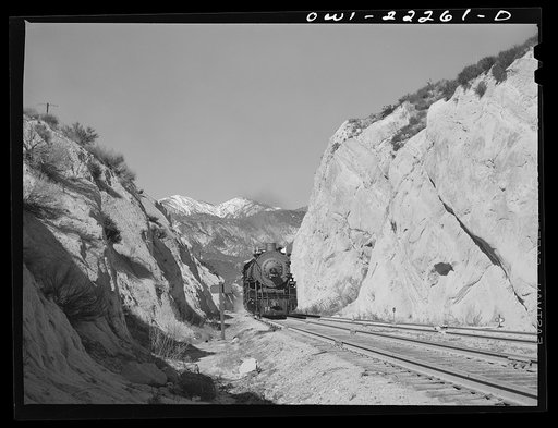 Eastbound Atchison, Topeka, and Santa Fe freight train near Cajon, California climbing the steep grade from San Bernardino to Summit
