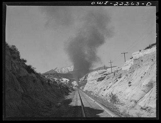 Untitled photo, possibly related to: Eastbound Atchison, Topeka, and Santa Fe freight train near Cajon, California climbing the steep grade from San Bernardino to Summit