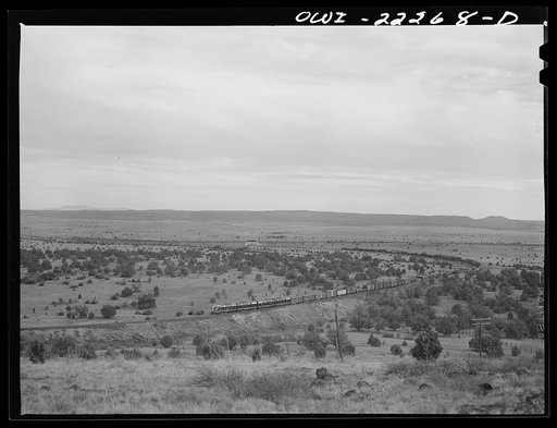 Atchison, Topeka, and Santa Fe Railroad diesel freight train going a curve near Gleed, Arizona enroute to Seligman