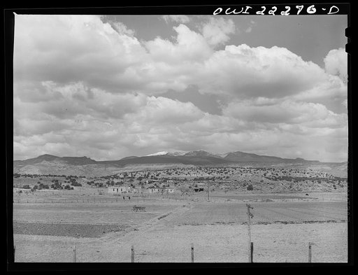 Indian farms and houses near Laguna, New Mexico enroute to Gallup on the Atchison, Topeka, and Santa Fe Railroad. In the background is Mount Taylor