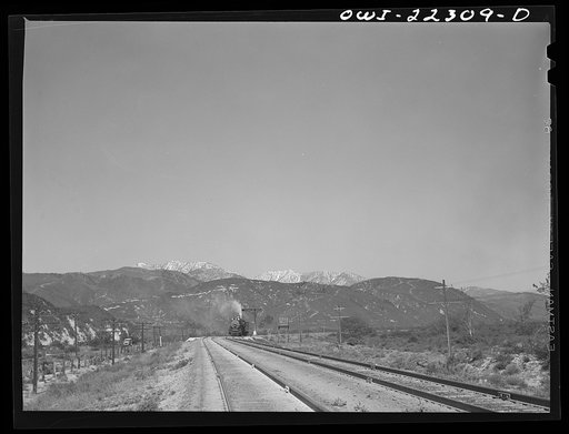 San Bernardino (vicinity), California. Atchison, Topeka and Santa Fe Railroad helper engine returning to the yard after having pushed a freight train up the steep grade to Summit