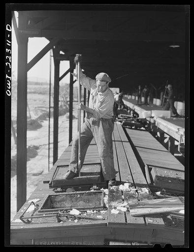Untitled photo, possibly related to: San Bernardino, California. Icing Atchison, Topeka and Santa Fe Railroad refrigerator cars at the ice plant
