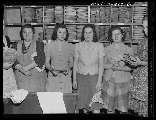 Philadelphia, Pennsylvania. Women order assemblers in front of seed racks at the W. Atlee Burpee Company, seed dealers