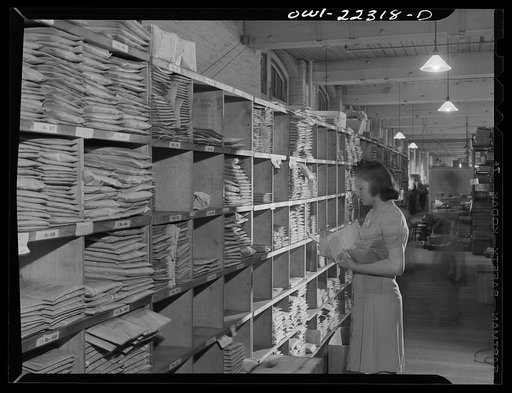 Philadelphia, Pennsylvania. Finding seed package in seed rack at the W. Atlee Burpee Company, seed dealers