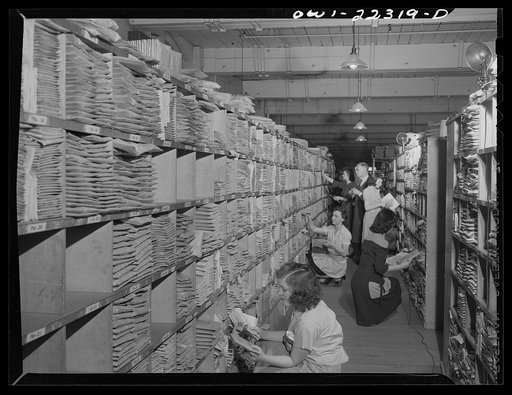 Philadelphia, Pennsylvania. Finding seed package in seed rack at the W. Atlee Burpee Company, seed dealers