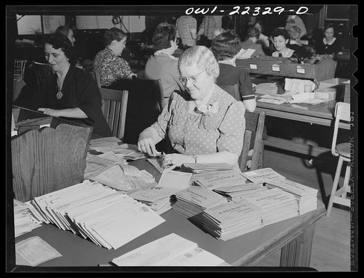 Philadelphia, Pennsylvania. Slitting the sides of envelopes with a paper knife at the W. Atlee Burpee Company, seed dealers