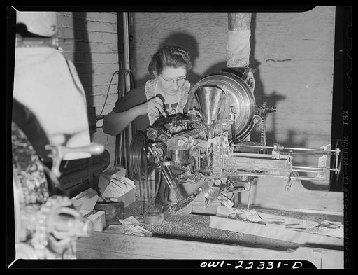 Philadelphia, Pennsylvania. Adjusting the seed counting machine at the W. Atlee Burpee Company, seed dealers