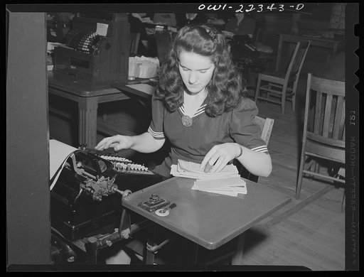 Philadelphia, Pennsylvania. Girl in the office adding up checks on an adding machine at the W. Atlee Burpee Company, seed dealers