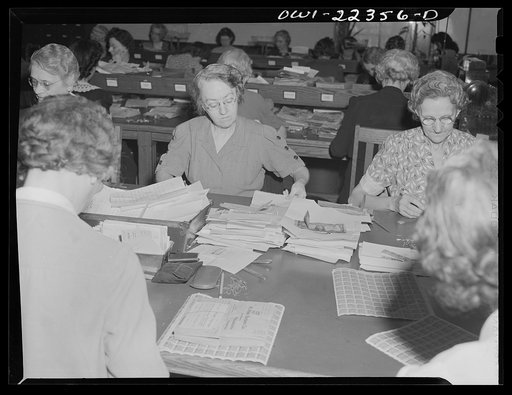 Philadelphia, Pennsylvania. Checking money received in envelopes at the W. Atlee Burpee Company, seed dealers