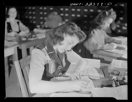 Untitled photo, possibly related to: Philadelphia, Pennsylvania. Checking seed order against catalog at the W. Atlee Burpee Company, seed dealers