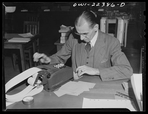 Philadelphia, Pennsylvania. Accountant assembling the day's returns at the W. Atlee Burpee Company, seed dealers