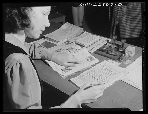 Philadelphia, Pennsylvania. Checking an order against the catalog at the W. Atlee Burpee Company, seed dealers