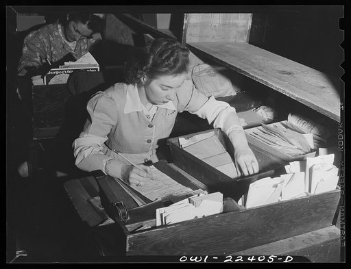 Philadelphia, Pennsylvania. Weighing out a bulk order of seed at the W. Atlee Burpee Company, seed dealers