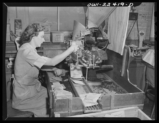 Philadelphia, Pennsylvania. Seed filling machine at the W. Atlee Burpee Company, seed dealers