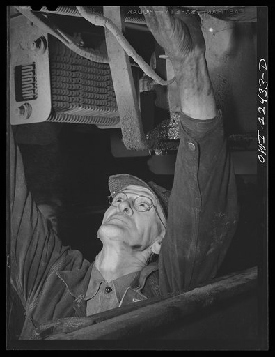 Baltimore, Maryland. Checking the electrical connections underneath a trolley at the Park Terminal. Trolleys are checked in a routine fashion daily and are sent to the maintenance terminal every few weeks