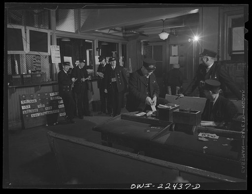 Baltimore, Maryland. Trolley conductors check in with the dispatcher behind the cage in the rear; pick up transfers, and count their receipts in this room at the Park Terminal, the dispatching center of the Baltimore Transit Company