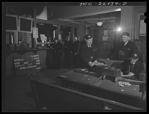 Untitled photo, possibly related to: Baltimore, Maryland. Trolley conductors check in with the dispatcher behind the cage in the rear; pick up transfers, and count their receipts in this room at the Park Terminal, the dispatching center of the Baltimore Transit Company