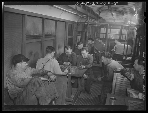 Baltimore, Maryland. Employees at the maintenance terminal of the Baltimore Transit Company having lunch and playing checkers in an old trolley made into a smoker
