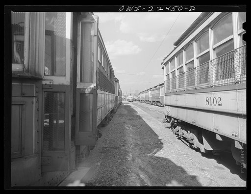 Baltimore, Maryland. The yard of Washington terminal, maintenance plant of the Baltimore Transit Company. Most of these trolleys can be reconditioned for use if wartime needs so require. In the distance are trackless trolleys