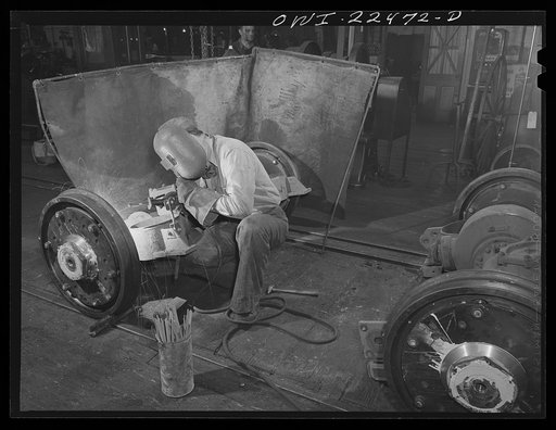 Baltimore, Maryland. Welding damaged steel plates which hold rubber sandwiches in the wheels of PCC trolleys at the machine shop of the Washington terminal, maintenance plant of the Baltimore Transit Company